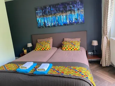 a bedroom with two beds with towels on them at Huis van Steen in Lelystad