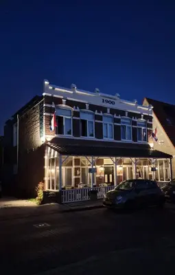 a building with a car parked in front of it at Pension Zee en Duinzicht in Zandvoort