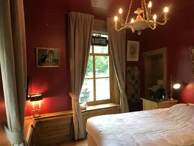 a bedroom with a white bed and a window at Logement Swaenenvecht in Utrecht