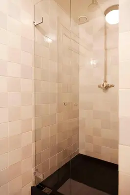 a bathroom with a shower with a glass door at Logement Swaenenvecht in Utrecht