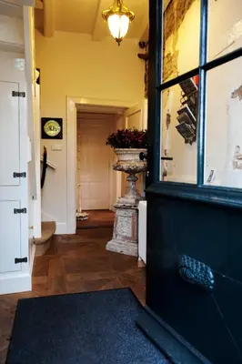 a hallway with a door with a vase in it at Logement Swaenenvecht in Utrecht