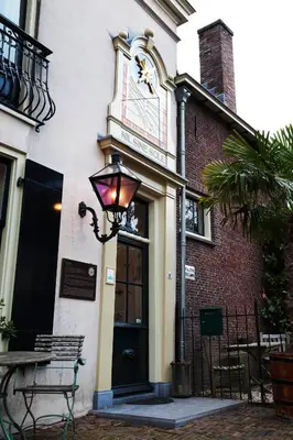 a building with a clock on the side of it at Logement Swaenenvecht in Utrecht