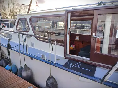 a boat with a welcome sign on the side of it at Motorjacht Flint in Amsterdam