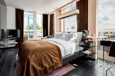 a bedroom with a large bed and a balcony at Sir Albert Hotel, part of Sircle Collection in Amsterdam