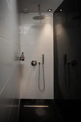 a bathroom with a shower with a glass door at Sir Albert Hotel, part of Sircle Collection in Amsterdam