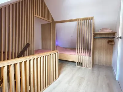 a small room with a bunk bed and a staircase at Casa Bon Bini in Egmond aan Zee