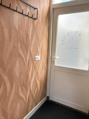 a room with a door with a wooden wall at Casa Bon Bini in Egmond aan Zee