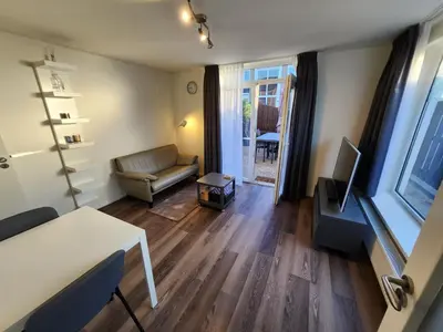 a living room with a couch and a table at FlipFlop in Noordwijk aan Zee