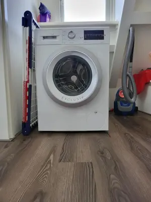 a washing machine is sitting in a room at FlipFlop in Noordwijk aan Zee