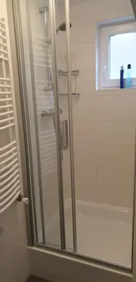 a bathroom with a shower with a glass door at FlipFlop in Noordwijk aan Zee