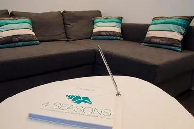 a table with a sign on it in front of a couch at 4 Seasons Zandvoort in Zandvoort