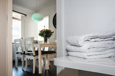 a dining room with a table and a pile of towels at 4 Seasons Zandvoort in Zandvoort