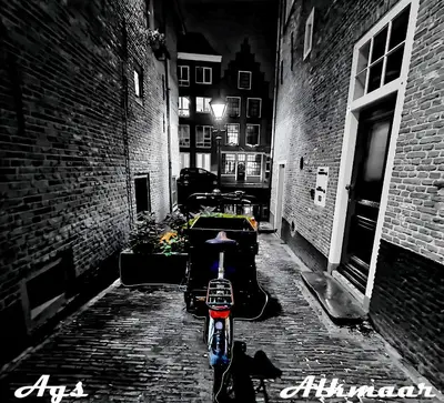 a motorcycle parked in an alley at night at Bed & Breakfast Prins Hendrik (Zuidschermer) in Zuidschermer