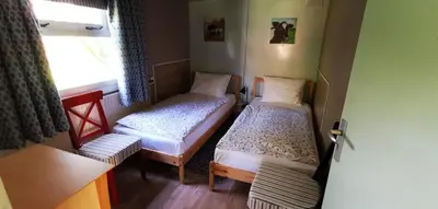 a small room with two beds and a window at Bed & Breakfast Prins Hendrik (Zuidschermer) in Zuidschermer