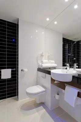 a bathroom with a sink and a toilet and a mirror at Holiday Inn Express Amsterdam - South by IHG in Amsterdam
