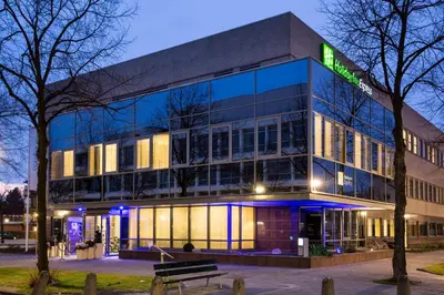 a building with a sign on the side of it at Holiday Inn Express Amsterdam - South by IHG in Amsterdam
