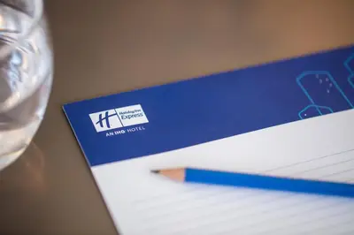 a blue envelope sitting on top of a table with a pen at Holiday Inn Express Amsterdam - South by IHG in Amsterdam