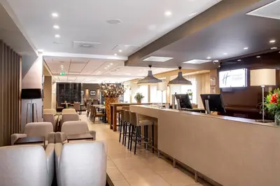a bar in a restaurant with chairs and a counter at Holiday Inn Express Amsterdam - South by IHG in Amsterdam