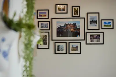 a group of framed pictures on a wall at Treehouse Inn in Duivendrecht