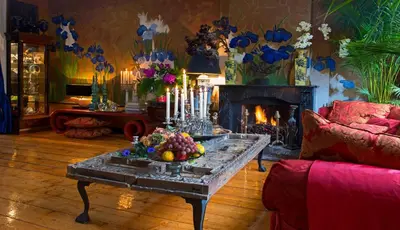 a living room with a table and a fireplace at Breitner House in Amsterdam