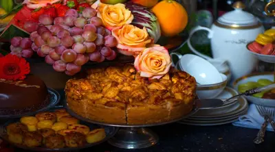 a cake with roses on top of it on a table at Breitner House in Amsterdam