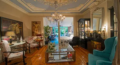 a living room with a chandelier and a table in a room at Breitner House in Amsterdam