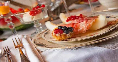 a plate with a fruit tart on a table at Breitner House in Amsterdam