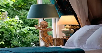 a lamp on a table next to a bed at Breitner House in Amsterdam