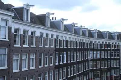 a row of brick buildings with white windows at Olive Bed and Breakfast in Amsterdam