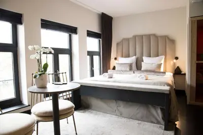 a bedroom with a large bed and a table at House of Amstel in Amsterdam