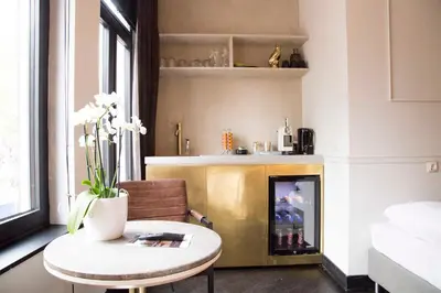 a living room with a table and a fireplace at House of Amstel in Amsterdam