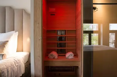 a room with a bedroom with a bed and a window at House of Amstel in Amsterdam