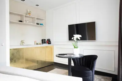 a kitchen with a table with a vase of flowers at House of Amstel in Amsterdam