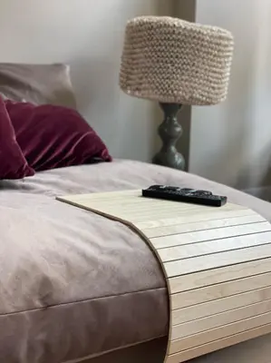 a remote control sitting on top of a bed at Stylish * Sunny * Cosy House in Heemstede