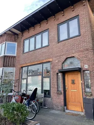 a bike parked in front of a brick building at Stylish * Sunny * Cosy House in Heemstede