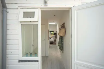 a hallway with a door leading into a house at The Bond Studio FREE PARKING in Zandvoort
