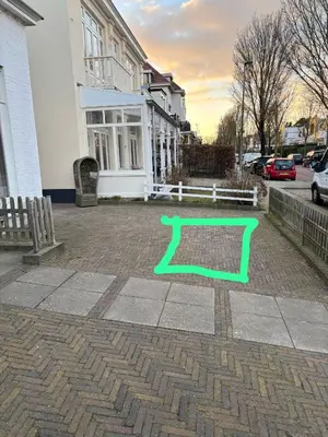 a green rectangle on a sidewalk in front of a building at The Bond Studio FREE PARKING in Zandvoort