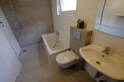 a bathroom with a shower and a toilet and a sink at Citycenter Residence in Amsterdam