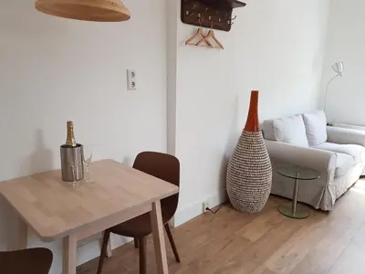 a living room with a table and a couch at Picco Bello in Zandvoort