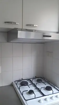 a white stove top oven in a kitchen at Picco Bello in Zandvoort