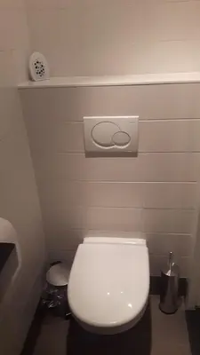 a bathroom with a white toilet in a room at Picco Bello in Zandvoort