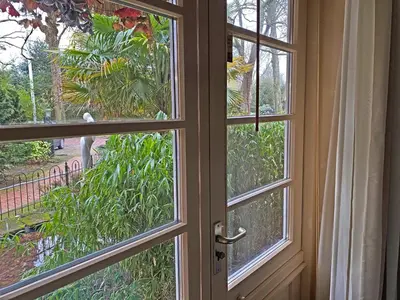 an open door with a view of a garden at Villa Prinsenhof # Eén in Bergen