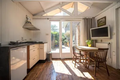 a kitchen with a table and chairs and a window at Ocho in Zandvoort