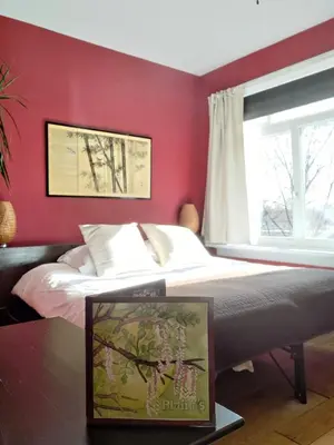 a red bedroom with a bed and a window at Blaine's: A B&B and private dining.... in Amsterdam