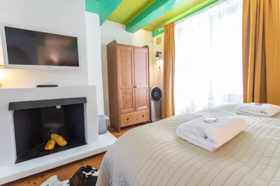 a bedroom with a bed with a fireplace and a flat screen tv at Tulip of Amsterdam in Amsterdam