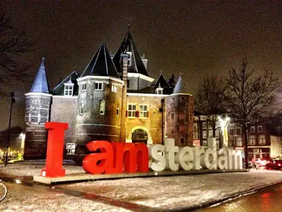 a large building with a sign in front of it at Tulip of Amsterdam in Amsterdam