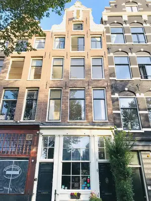 a large building with windows on a city street at Tulip of Amsterdam in Amsterdam