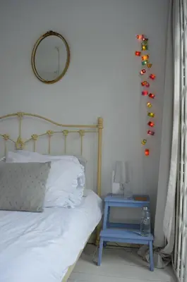 a bedroom with a bed with a blue nightstand and a mirror at Bed & Breakfast Jo Amsterdam in Amsterdam