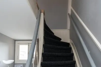 a staircase in a house with a black stair case at Westerpark Suites in Amsterdam