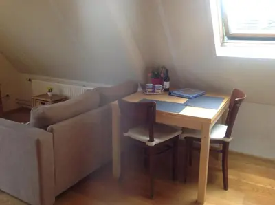 a living room with a table and a couch at De Slotruine in Egmond aan den Hoef
